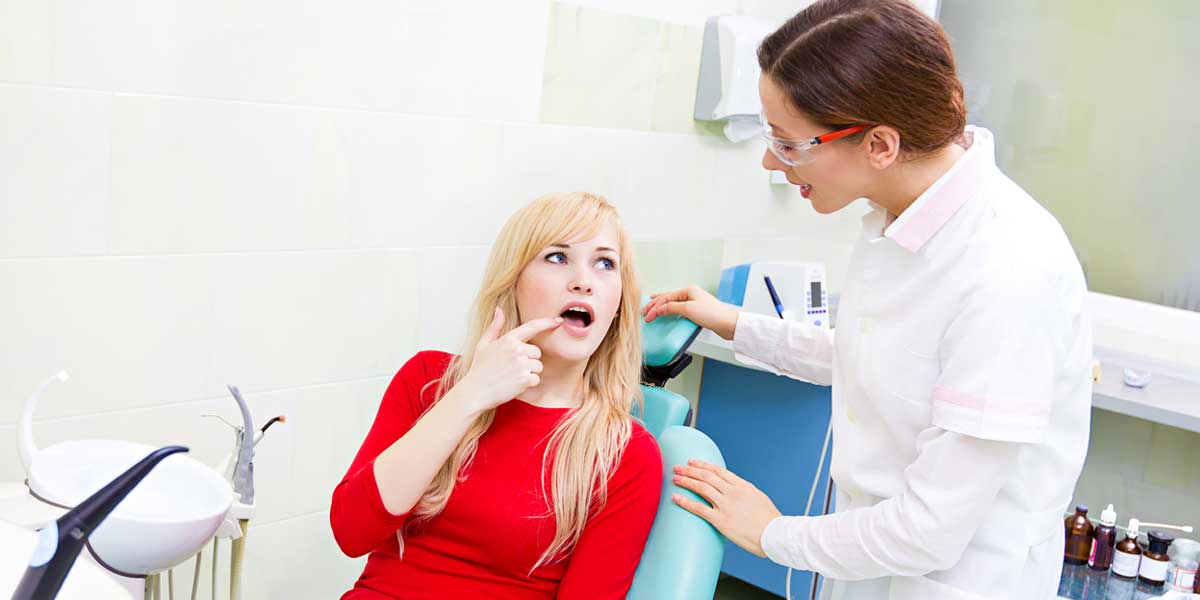 Patient is Showing Her Painful Tooth to Doctor